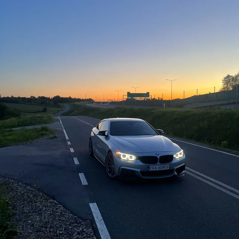 BMW serii 4 o zachodzie słońca na podkrakowskiej drodze - motoryzacyjna pasja zespołu Penthouse Office